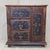 A charming and functional antique late 1800s or early 1900s Romanian pine cupboard that was hand painted in floral motifs...