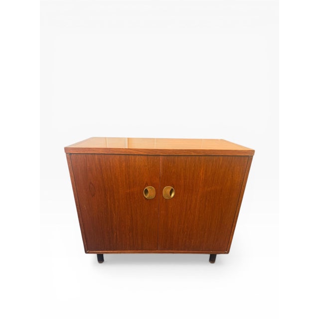 This elegant mid-century modern cabinet by Baker Furniture showcases the brand’s signature craftsmanship and refined...