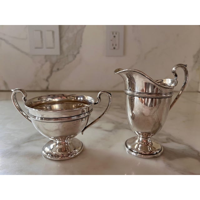 This elegant sterling silver Creme and Sugar Set, circa 1940's, would be a lovely addition to any setting. The simplicity,...