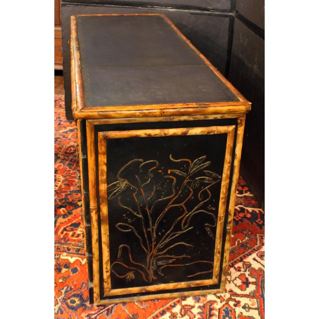 English circa 1880s bamboo and faux lacquer double pedestal desk. Original Aesthetic Movement brass pulls. Front bracket...