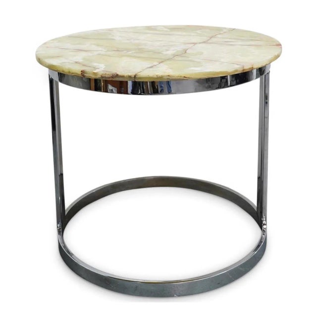 Designer round table featuring an onyx top mounted on a chrome plated metal base. CIRCA: 20 middle Ct ORIGIN: Italy