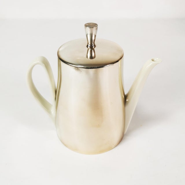 This jug was manufactured by hke in germany in the 1950s. it features an art deco design. the insert (porcelain jug) and...