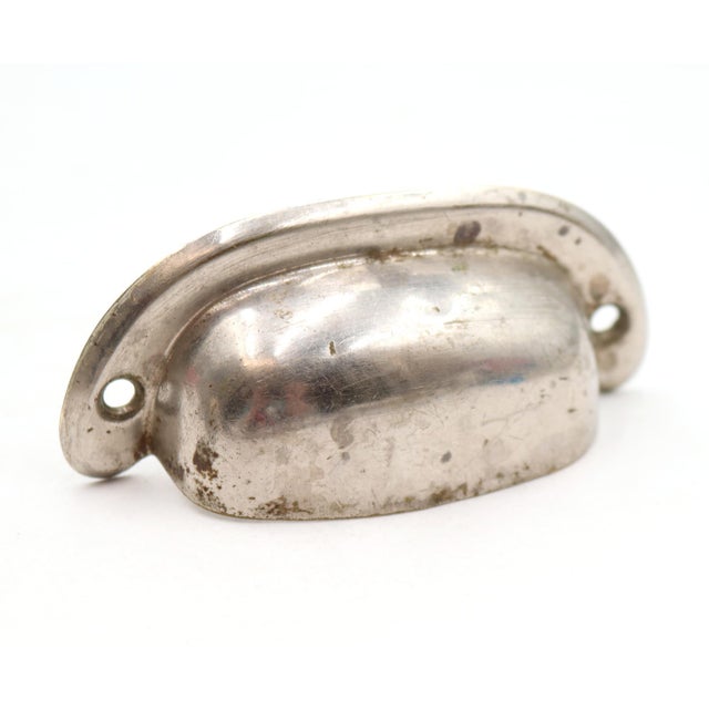 Classic style bin cup drawer pulls made of brass with a polished nickel finish. The original mounting screws are not...
