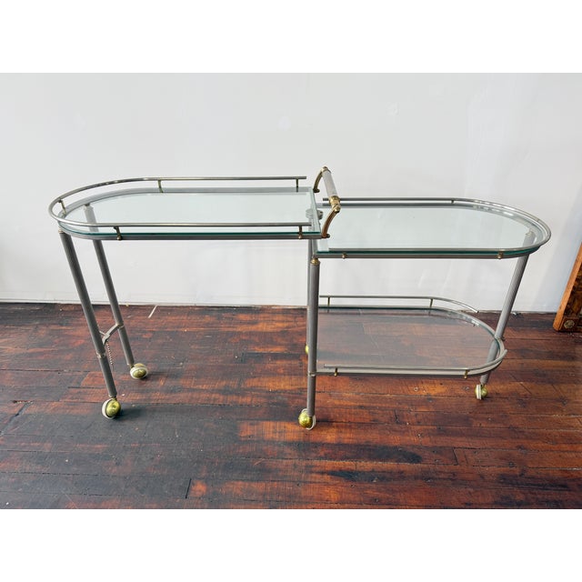 Refined and architectural, this French two-tier bar cart is executed in a cool-toned metal frame with crisply fluted,...