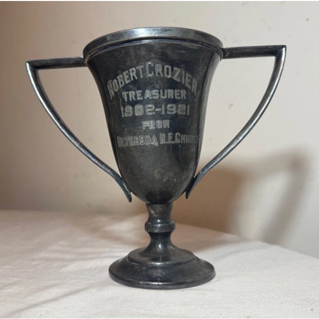 Up for sale is a lovely antique silverplate trophy award from 1902-1921, featuring an engraved design on the face for the...