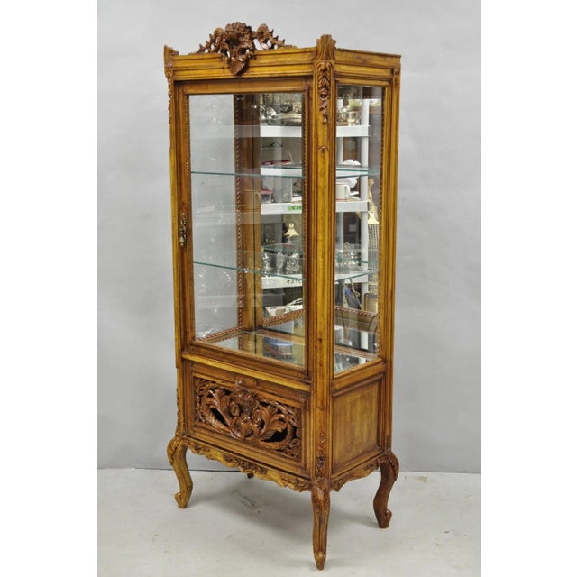 Vintage French Baroque Style Carved Wood & Glass Curio China Display Cabinet. Item features a mirror back and mirror lower...