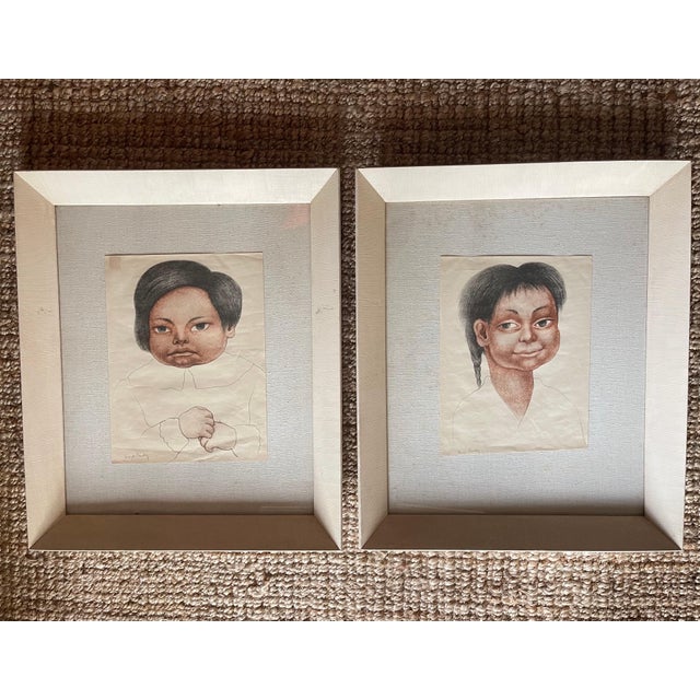 Pair of vintage prints of Diego Rivera's drawings of indigenous Mexican children. Framed on linen board in a pair of...