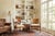 A handsome pair of Anglo-Indian style armchairs crafted in warm honey-toned hardwood, featuring gracefully scrolled open...