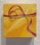 This artwork features a vibrant gold gift box tied with a delicate pink ribbon, set against a warm yellow background. The...