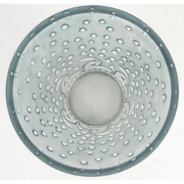 "Ajaccio" vase, created in 1938 in pressed, molded white glass with a blue patina, signed R. Lalique under the base....