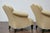 A vintage pair of French lounge chairs with rolled arms, camelbacks, ebonized legs and upholstery. This vintage pair of...