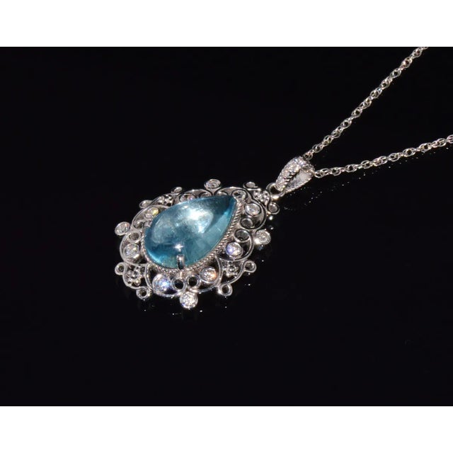 Top quality natural aquamarine and diamond pendant with a gorgeous filigree floral design. This finely crafted 18K solid...