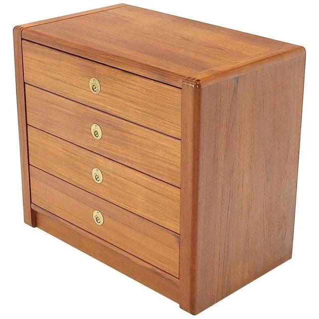 Mid-Century Modern teak bachelor chest dresser. Recessed brass pulls.