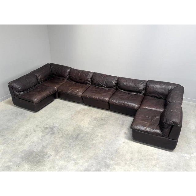 Remarks: Mid century modular sofa from the 1970s by Rolf Benz. 7 Elements, upholstered in chocolate brown leather. Three...