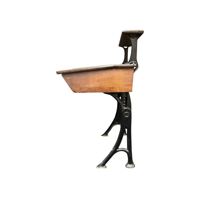 This Heywood Eclipse child's school desk with an integrated shelf has a lovely patina and shows signs of wear that add to...