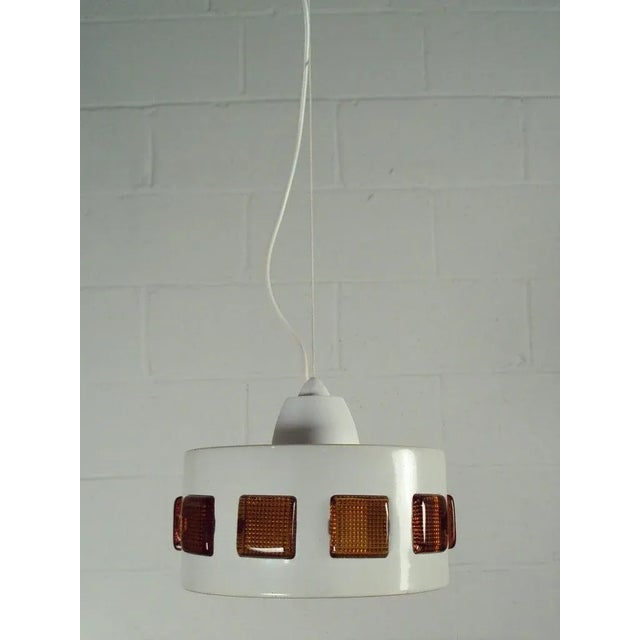 Vintage Mid-Century Swedish Modern Pendant in a cloud white enamel coated finish with amber colored glass tiles. Newly...