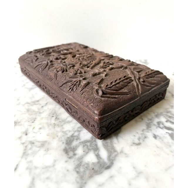 Stunning and far antique wood jewelry/trinket box. Possibly made in Africa. The box depicts various animals in a fauna...