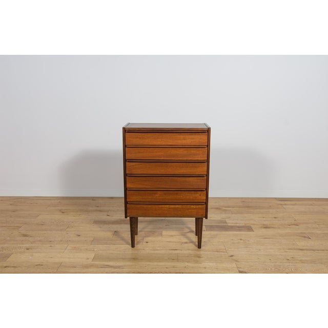 Teak dresser with six drawers made in the 1960s in united Knigdom. The dresser has contoured handles. The dresser has...