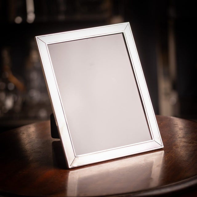 A vintage 20th century solid silver photograph frame. Decorated with an engine turned detail, this frame can be used both...