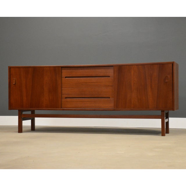 A mid century modern teak sideboard credenza by Nils Jonsson for Troed. Two sliding doors. Professionally refinished....