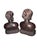An exceptional and striking pair of mid-century, hand-carved solid hardwood bust statues depicting a man and a woman....