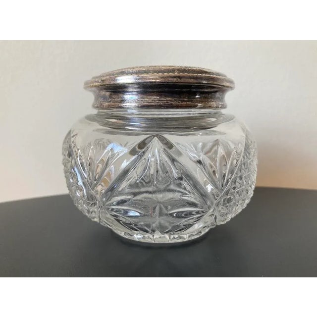 A beautiful art glass jar and silver plate lid, circa early 20th century, England. Silver lid is decorated with embossed...