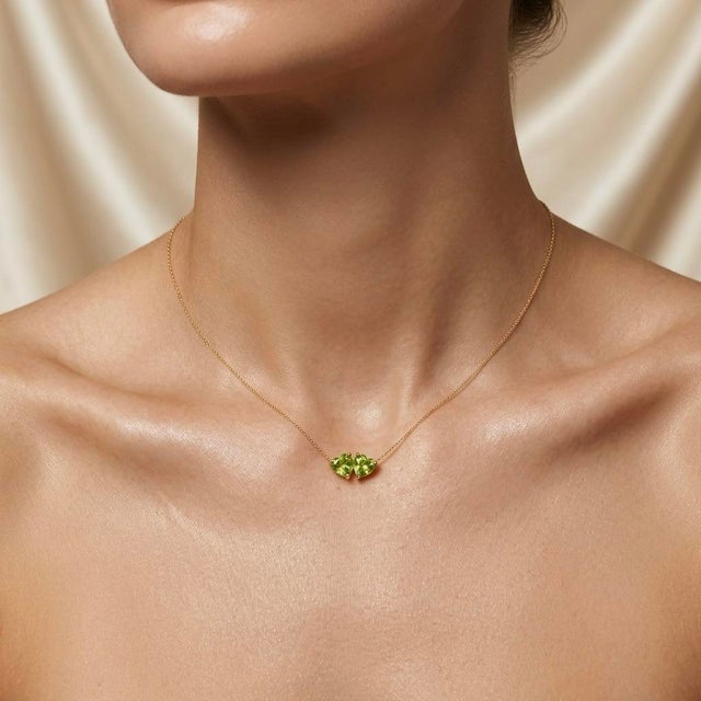 Brighten your jewelry collection with this fresh two-stone pendant necklace, featuring two sparkling lime-green gemstones...