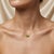Brighten your jewelry collection with this fresh two-stone pendant necklace, featuring two sparkling lime-green gemstones...