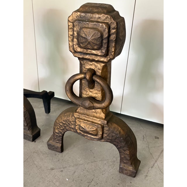 Ornate pair of Cahill Fireplace Metal andirons. Gold/bronze painted metal with heavy rings on center hand hammered...