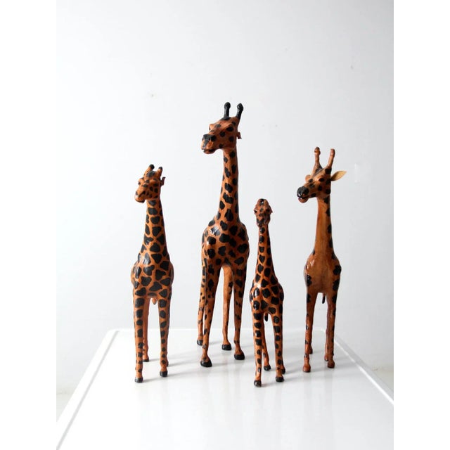 This is a set of four vintage leather giraffes sculptures. The hand-crafted figures feature beautifully painted leather...