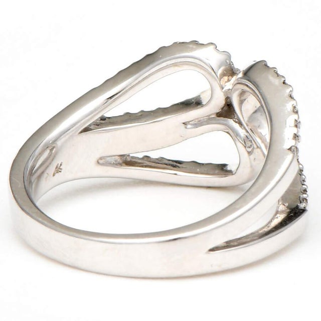 Three graceful loops of gorgeous diamonds set in white gold will make this ring look splendid on the recipient's hand....