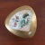 This vintage gold lusterware porcelain trinket box from Japan features a delicate fan design adorned with floral motifs...