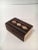 A small walnut and wood box with very handsome details on side and inlaid in brass. The top pivots upwards and does not...