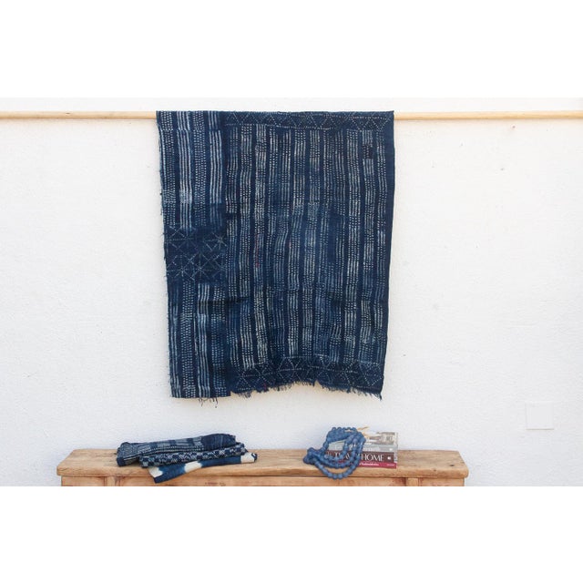A masterwork of Malian textile heritage featuring deep indigo saturation and symbolic geometric motifs. Originating from...