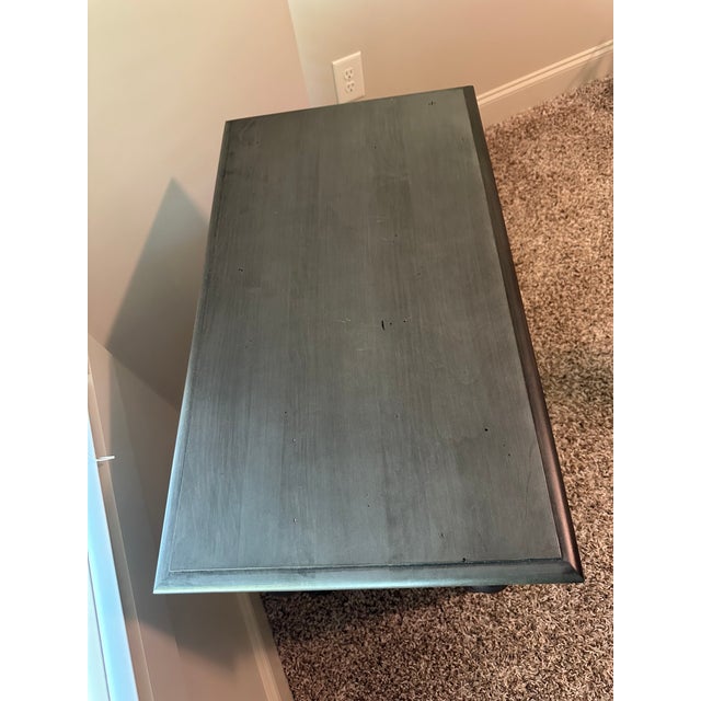 Finish is "Shark Fin." From Ethan Allen website: With repeated ring leg turnings inspired by louvered panels and gorgeous...