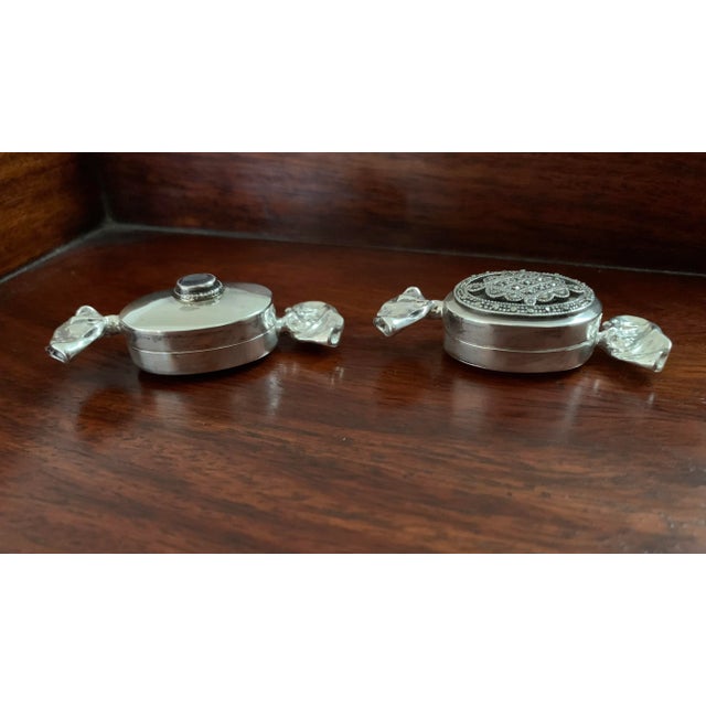 So pretty and dainty these two silver trinket boxes are a delight. One is topped off with a small amethyst. The other one...