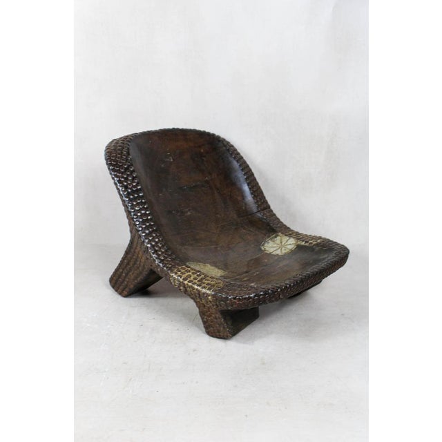 This carved vintage stool is a stunning piece of traditional African craftsmanship. Hand-carved from solid wood, it...