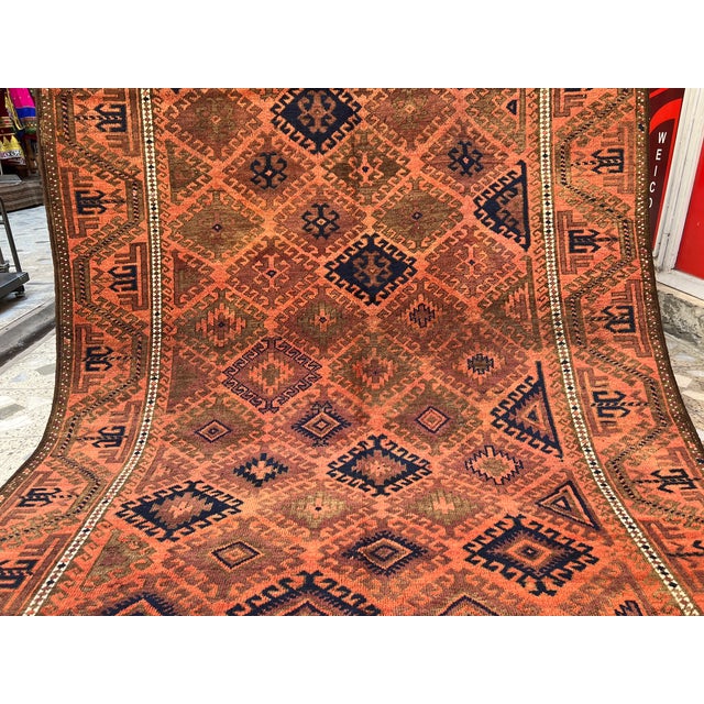 This rare antique hand-knotted wool area rug showcases a highly collectible Turkmen Yomut tribal design. The center field...