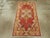 A vintage Turkish Oushak throw rug. A serrated edge hexagonal mauve medallion sprouts four large, aggressive diagonal...