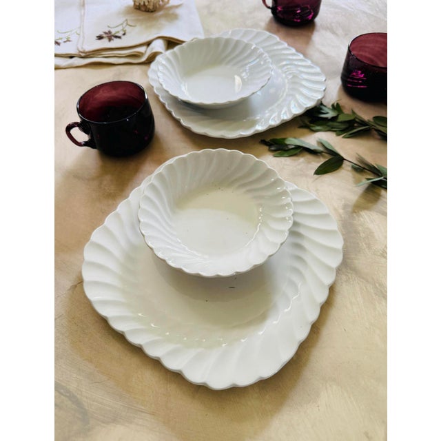 Lovely collection of four pieces, two small berry bowls, and two salad plates, made in England, presented in all white...