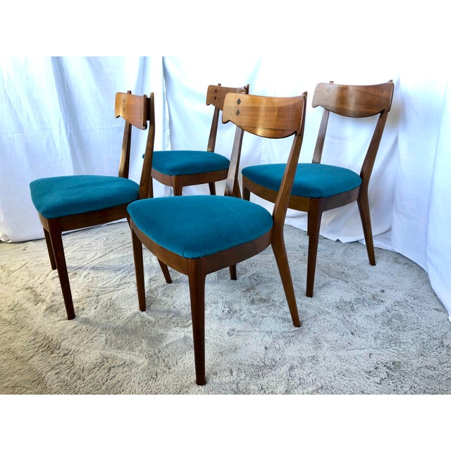 1960’s Declaration dining chairs designed by Kipp Stewart for Drexel. The chairs are walnut with inlaid diamond designs on...