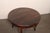 A French Provincial 45.75" round wooden table from the mid 20th century. This vintage table from France, crafted from...