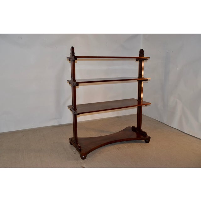 19th century English freestanding shelf made from mahogany. This gorgeous piece has three shelves, all supported by...