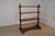 19th century English freestanding shelf made from mahogany. This gorgeous piece has three shelves, all supported by...