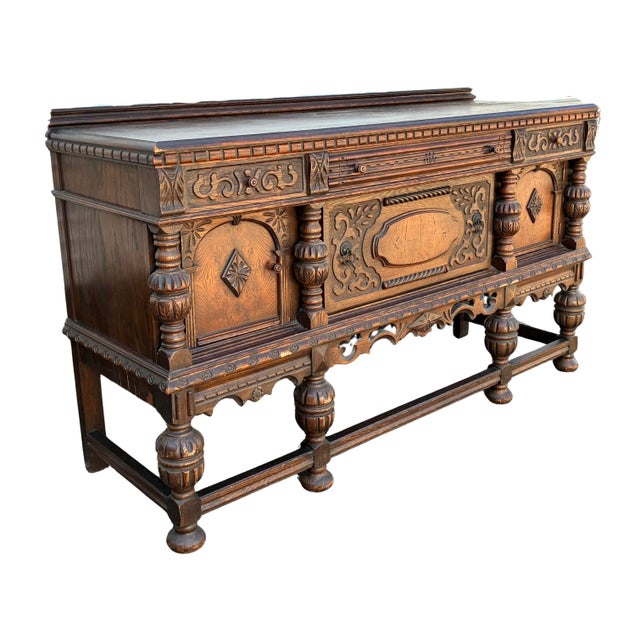 Impressive early 20th-century Jacobean Revival buffet or sideboard crafted in richly grained oak and extensively decorated...