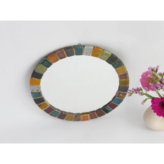 Vintage round mirror with colourful tiles in mosaic style made out of ceramic. The tiles have beautiful vibrant colours....