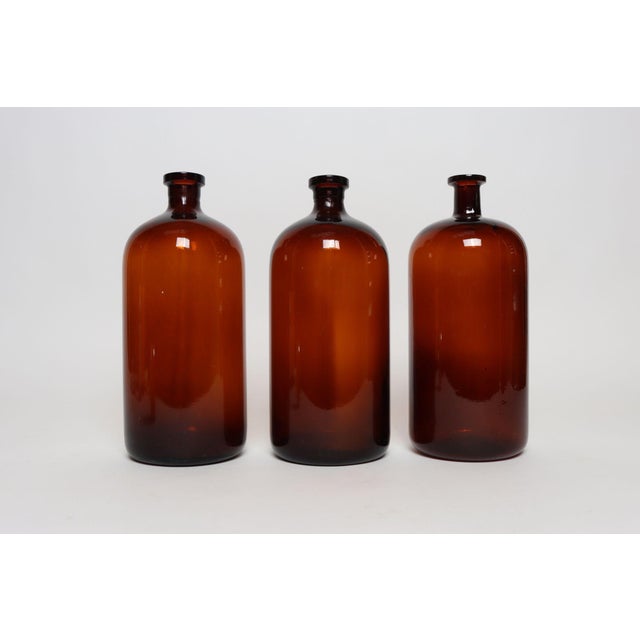 Set of three vintage American amber glass apothecary/medicine bottles known as "Druggist's Packing Bottles" coined by the...
