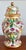 Hot pink and green decorated ceramic ginger jar with parrots on perched on bamboo branches. Wonderful tropical theme....