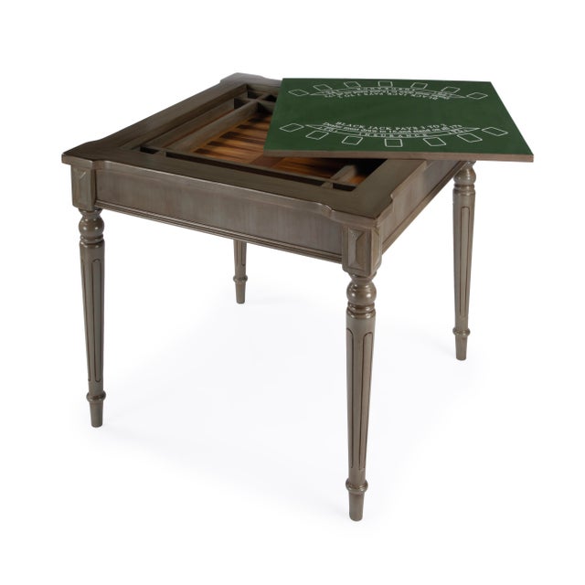 Play a variety of games on this stylish table that is veneered in a Silver Satin finish. The top inset has a game board...