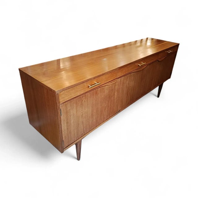 Classic teak sideboard with a mid-20th-century Scandinavian design. This sideboard features a highly practical design with...